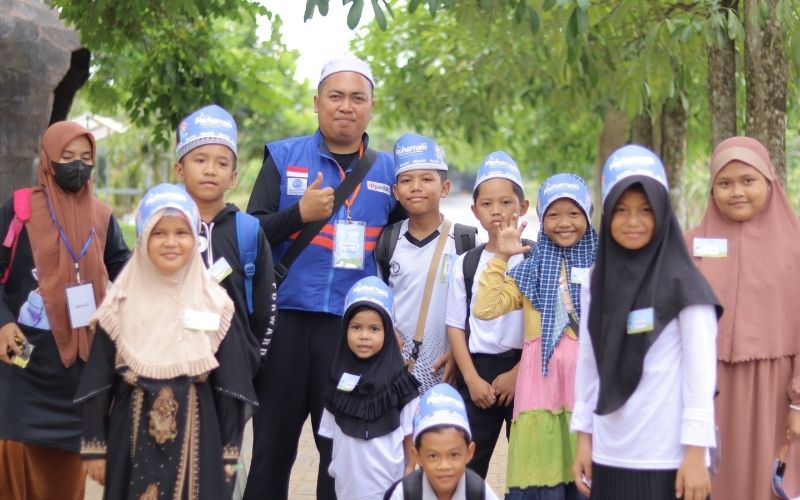 Children smiling and receiving aid