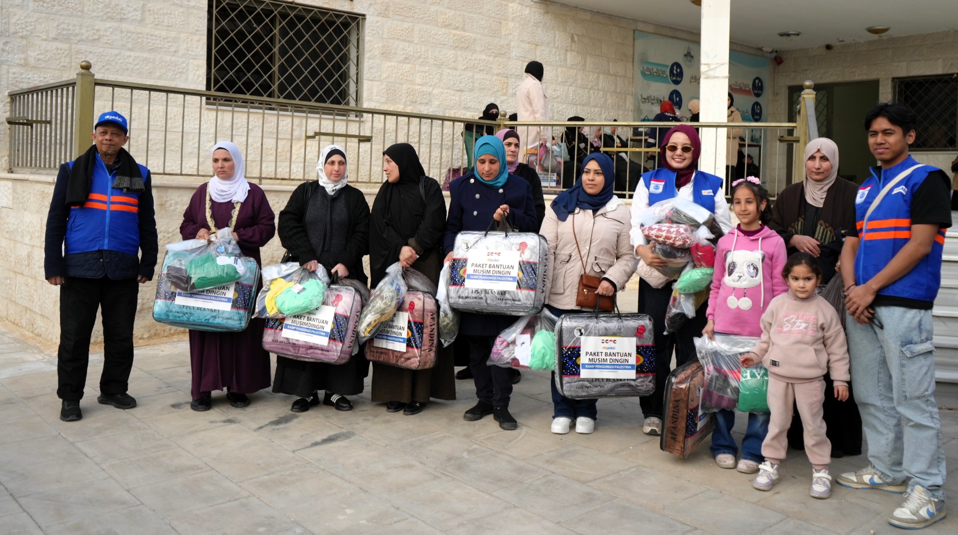 Palestinian refugees receiving iftar meal packages at Sukhnah Camp.