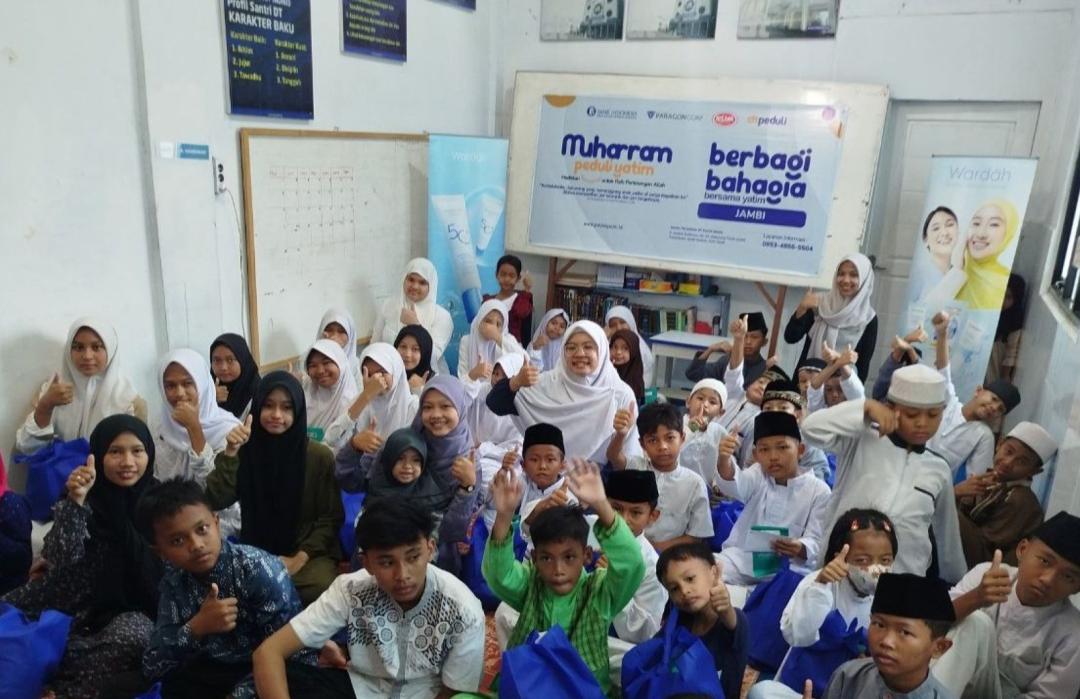 Orphaned children receiving gift packages during the Muharram Orphan Care Program.